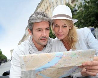 a couple looking down at a map